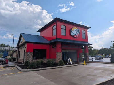 Outside of newly refreshed Moss Grove ZIPS Car Wash location with a bright, shining red exterior